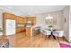 Bright kitchen area featuring a breakfast bar, and a dining area, all with hardwood floors at 8717 Vintner Ct, Indianapolis, IN 46256