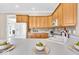 Bright kitchen featuring wooden cabinets, hardwood floors and a white countertop and sink area at 8717 Vintner Ct, Indianapolis, IN 46256