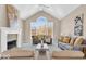 Bright and inviting living room with a fireplace and large arched window at 8717 Vintner Ct, Indianapolis, IN 46256