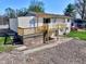 Exterior view of the rear of the home showcasing the wood deck and concrete pad at 8745 Big Bend Rd, Martinsville, IN 46151