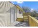 Home's back porch with white door and new wood plank fence, stairs to the porch and concrete pad at 8745 Big Bend Rd, Martinsville, IN 46151