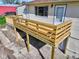 View of the new wood porch with a white door, and a red storage shed in the back at 8745 Big Bend Rd, Martinsville, IN 46151