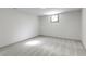 This is an unfinished basement featuring neutral walls, carpeting and a small window for natural light at 8745 Big Bend Rd, Martinsville, IN 46151