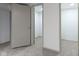 Neutral hallway leading to adjoining rooms with carpet and neutral paint at 8745 Big Bend Rd, Martinsville, IN 46151