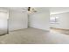 Open-concept living room with neutral carpet, ceiling fan, and natural light at 8745 Big Bend Rd, Martinsville, IN 46151