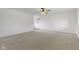 Bright and airy living room featuring neutral carpet, fan and ample natural light at 8745 Big Bend Rd, Martinsville, IN 46151