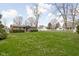 Expansive backyard with lush lawn and mature trees, offering plenty of space at 89 E Walnut St, Fountaintown, IN 46130