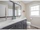 Bright bathroom featuring a dual sink vanity, modern fixtures, and a large window for natural light at 89 E Walnut St, Fountaintown, IN 46130