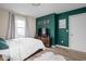 Cozy bedroom with comfortable bed, accent wall, and soft rug at 89 E Walnut St, Fountaintown, IN 46130