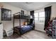 Bedroom featuring a bunk bed, hardwood flooring, a window with natural light, and neutral paint at 89 E Walnut St, Fountaintown, IN 46130