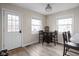 Dining area features a dark wood table with four chairs, and natural light from two windows at 89 E Walnut St, Fountaintown, IN 46130