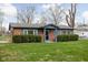 Inviting brick home with fresh green lawn and sculpted shrubbery enhancing curb appeal at 89 E Walnut St, Fountaintown, IN 46130
