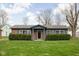 Charming brick ranch with well-maintained landscaping and inviting front porch at 89 E Walnut St, Fountaintown, IN 46130