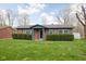 Inviting brick home with fresh green lawn and sculpted shrubbery enhancing curb appeal at 89 E Walnut St, Fountaintown, IN 46130