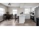 Kitchen featuring a central island with bar seating, stainless appliances, and wood floors at 89 E Walnut St, Fountaintown, IN 46130
