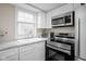 Kitchen area featuring stainless steel appliances, and white cabinets at 89 E Walnut St, Fountaintown, IN 46130
