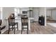 Kitchen featuring a central island with bar seating, stainless appliances, and wood floors at 89 E Walnut St, Fountaintown, IN 46130