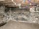 Utility basement with block walls, water damage, and exposed pipes and wiring at 918 N Dearborn St, Indianapolis, IN 46201