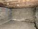 Unfinished basement featuring concrete block walls and exposed ceiling beams at 918 N Dearborn St, Indianapolis, IN 46201