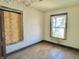 Empty bedroom with peeling paint and plywood covered windows in need of repair at 918 N Dearborn St, Indianapolis, IN 46201