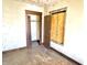 Dated bedroom showing boarded window, peeled ceiling, closet, and worn floor at 918 N Dearborn St, Indianapolis, IN 46201