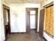 Old bedroom with closet, peeling paint, worn floor, and plywood covered windows at 918 N Dearborn St, Indianapolis, IN 46201