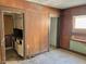 Dining room reveals an outdated design with wood paneling, worn flooring, and kitchen access at 918 N Dearborn St, Indianapolis, IN 46201