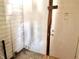 Mud room features worn walls, outdated paneling, damaged tile, and a weathered exterior door at 918 N Dearborn St, Indianapolis, IN 46201