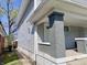 The light gray home boasts brick columns, a covered porch, and horizontal siding at 918 N Dearborn St, Indianapolis, IN 46201