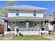 A two-story duplex features gray siding, a light gray roof, and covered front porches with brick columns at 918 N Dearborn St, Indianapolis, IN 46201
