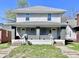 Two-story duplex with gray siding, covered front porches, and steps leading to separate entrances at 918 N Dearborn St, Indianapolis, IN 46201
