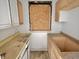 Dated kitchen with plywood covered window, countertops, and cabinets in need of repair at 918 N Dearborn St, Indianapolis, IN 46201