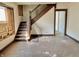 Living room with staircase, highlighting original wood details and an opportunity for customization at 918 N Dearborn St, Indianapolis, IN 46201