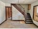 A room in disrepair with a staircase, walls, and flooring needing significant repair at 918 N Dearborn St, Indianapolis, IN 46201