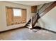 Living room featuring staircase and light-filled window, offering great potential for renovation at 918 N Dearborn St, Indianapolis, IN 46201
