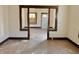 Open-concept living room featuring original wood columns and natural light, presenting renovation potential at 918 N Dearborn St, Indianapolis, IN 46201