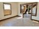 The living room offers hardwood floors and a view of the staircase, needing renovations at 918 N Dearborn St, Indianapolis, IN 46201