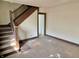 A spacious living room showcasing a classic staircase and an open layout, ready for remodeling at 918 N Dearborn St, Indianapolis, IN 46201