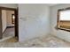 Needs-renovation room with damaged walls, floors, and a boarded-up window at 918 N Dearborn St, Indianapolis, IN 46201