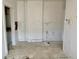 Incomplete room with peeling paint, damaged floor tiles, and dated electrical box at 918 N Dearborn St, Indianapolis, IN 46201