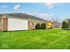 Expansive backyard features lush green grass, mature trees, and ample space for outdoor activities at 958 Tamarack Cir N Dr, Indianapolis, IN 46260