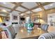 Open-concept dining room with wood beam ceilings, hardwood floors, and lots of natural light at 958 Tamarack Cir N Dr, Indianapolis, IN 46260