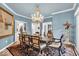Dining room featuring a chandelier, seating for six and light wood flooring at 958 Tamarack Cir N Dr, Indianapolis, IN 46260