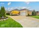 Well-maintained ranch home boasts an attached two-car garage, mature landscaping, and a welcoming front yard at 958 Tamarack Cir N Dr, Indianapolis, IN 46260