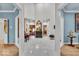 Grand foyer featuring high ceilings, white tile floors, and elegant architectural details at 958 Tamarack Cir N Dr, Indianapolis, IN 46260