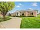 Lovely single-story brick home with a well-kept lawn, mature trees, and a welcoming driveway at 958 Tamarack Cir N Dr, Indianapolis, IN 46260