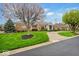 Charming brick home with well-maintained landscaping, a green lawn, and an inviting driveway at 958 Tamarack Cir N Dr, Indianapolis, IN 46260