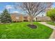 Beautiful brick home showcasing a well-manicured lawn and mature trees at 958 Tamarack Cir N Dr, Indianapolis, IN 46260