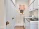 Well-equipped laundry room with washer, dryer, and ample storage space at 958 Tamarack Cir N Dr, Indianapolis, IN 46260