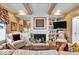 Inviting living room featuring beamed ceilings, a fireplace, and stylish decor for comfortable living at 958 Tamarack Cir N Dr, Indianapolis, IN 46260